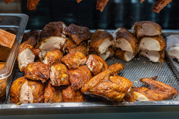 Pile of roasted chicken legs for sale at Chinese restaurant