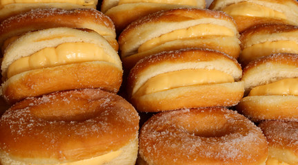 many sugar-coated donuts in a pastry shop
