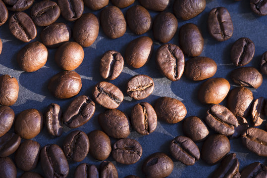 Roasted Black Coffee Beans Background On Granite Stone