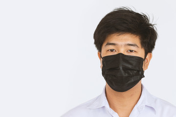 closeup men wearing a mask to protect the coronavirus (COVIT-19) with soft-focus and over light in the background