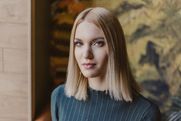 portrait of an attractive young blonde close-up in a cafe. the face of a beautiful girl.
