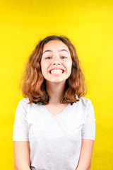 Cute teenager girl with funny face smiling with teeth to camera