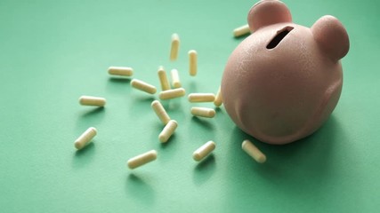 concept of expensive drugs. pills and tablets fall moneybox. slow motion video - Powered by Adobe