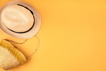 Flat lay with summer accessories for woman. Sun hat and bag. Summer travel, vacatoins, heat protection concept.