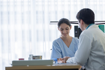 A doctor take care of sick patient woman at the hospital or medical clinic.