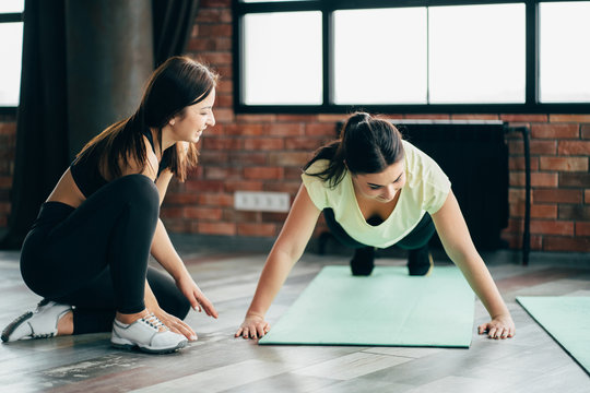Woman working out with personal trainer support