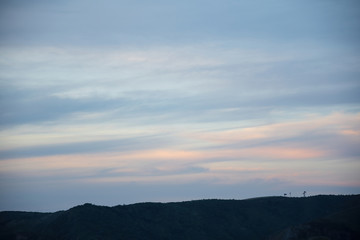 View of pastel sky over hill ridge after sunset