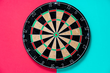 target dart board on the red and table background, center point, head to target marketing and business success concept