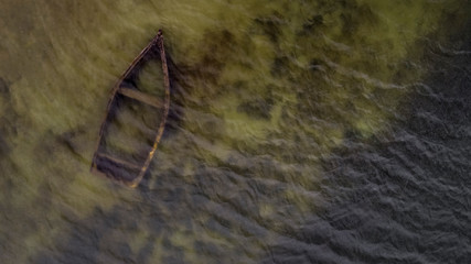 Aerial view of a sunken boat on Querococha lake, on the way to Chavin de Huantar city in Ancash, Peru