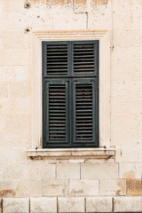 Minimal travel concept. Green wood shutters on old building. Front view. Old town and architecture in Europe,, Croatia, Dubrovnik.