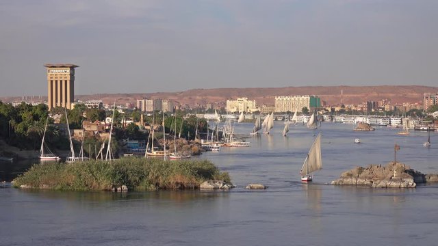 Beautiful landscape with felucca boats on Nile river in Aswan at sunset, Egypt, 4k