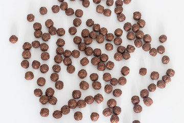 Chocolate cereal balls isolated on white background with copy space. Healthy breakfast concept. Top view.