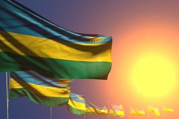 wonderful many Rwanda flags on sunset placed diagonal with soft focus and place for your text - any holiday flag 3d illustration..