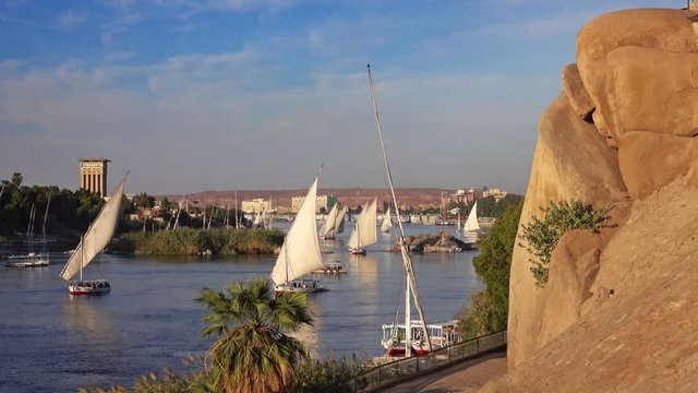 Beautiful landscape with felucca boats on Nile river in Aswan at sunset, Egypt, 4k