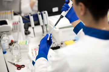Research scientist doing biochemical blood test in science lab