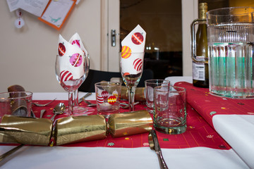 Childrens table laid for christmas dinner with a golden cracker