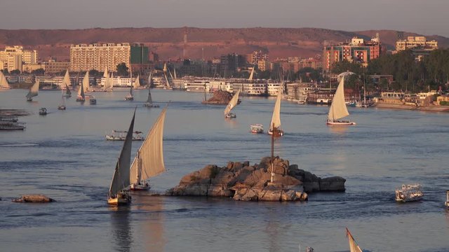 Beautiful landscape with felucca boats on Nile river in Aswan at sunset, Egypt, 4k