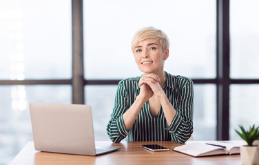 Confident Businesswoman Sitting At Laptop Smiling Posing In Modern Office