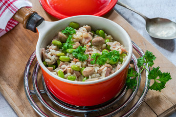 Bacon and mushroom risotto with edamame beans in a saucepan