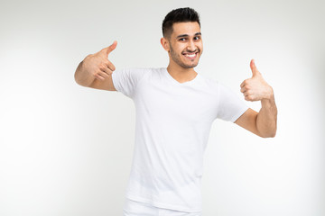 guy in a white t-shirt with a layout on a white studio background