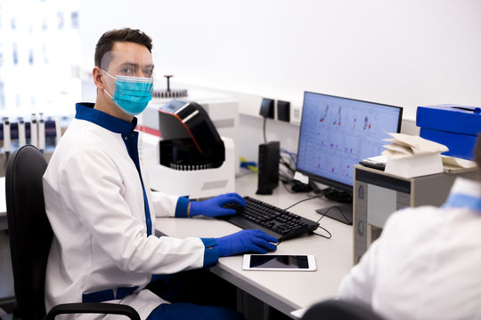 Male scientist sitting at the table with modern computer