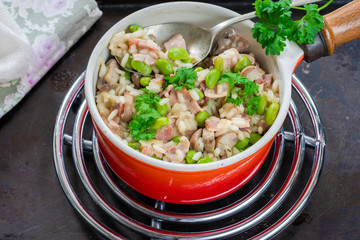Bacon and mushroom risotto with edamame beans in a saucepan