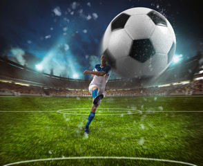 Obraz na płótnie Canvas Football scene at night match with player in a white and blue uniform kicking the ball with power