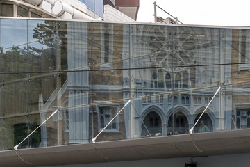 St. Mary of the Angels facade reflects on glass facade, Wellington, New Zealand