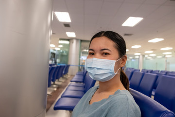 Fototapeta na wymiar Asian girl use a protection mask for coronavirus or covid 19 in airport