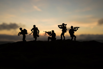 Fototapeta na wymiar Battle scene. Military silhouettes fighting scene on war fog sky background. World War Soldiers Silhouettes Below Cloudy Skyline At sunset.