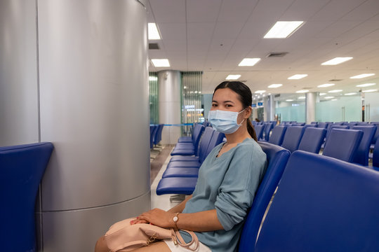 Asian girl use a protection mask for coronavirus or covid 19 in airport