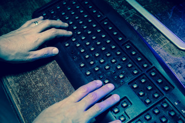 Hammer on computer keyboard with damaged keys