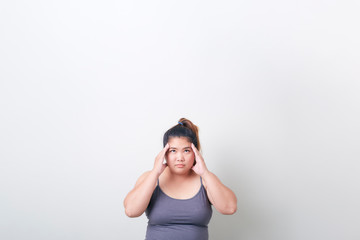 plump woman headache in exercise clothes