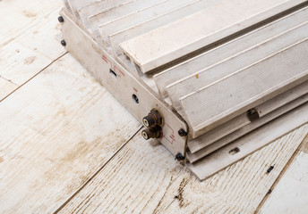 Old white 12v power amplifier on wood floor, hi grade grade technology