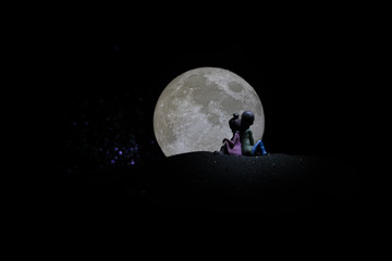 Young couple in love at beautiful moon of night.
