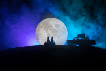 Young couple in love at beautiful moon of night.
