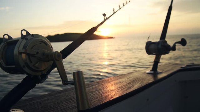 Deep sea fishing rods on a fishing boat at sunrise