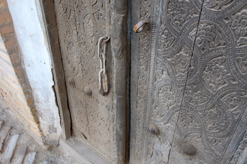 Old wooden door (with chain lock). Khiva, Uzbekistan.