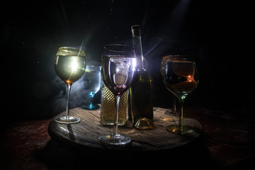 Goblet of white wine on wooden table on wooden wall background