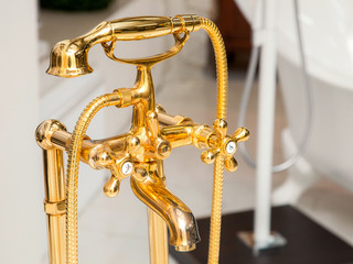 shower faucet with valve taps and a mixer of gold color in retro style, shower diffuser close up.