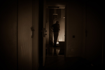Horror silhouette of person in window. Scary halloween concept Blurred silhouette of witch in...
