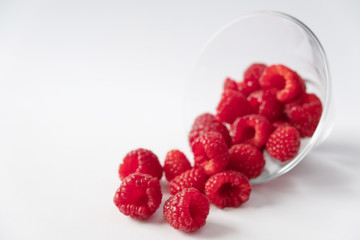 Raspberries in cristal bowl on white background
