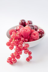 Berries in white bowl on white background