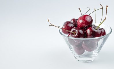 Cherries in cristal bowl on white background