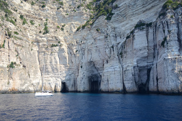 Fototapeta na wymiar Blue cave in the middle, the cave which is in the turist circuit of the Paxos island.