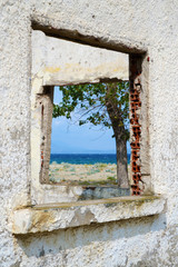 Window to the sea. The sea viewed through an old disaffected window