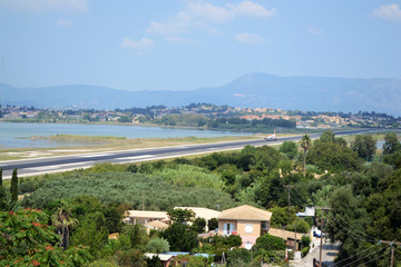 Airplane Airbus A320 over the Corfu town in Greece.