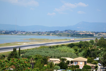 Fototapeta na wymiar Corfu Town - airport. Airplane Airbus A320 over the Corfu town in Greece.