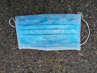 medical mask used on the asphalt