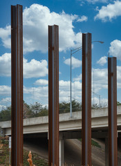 Four Steel Beams Poking into the Sky by a bridge